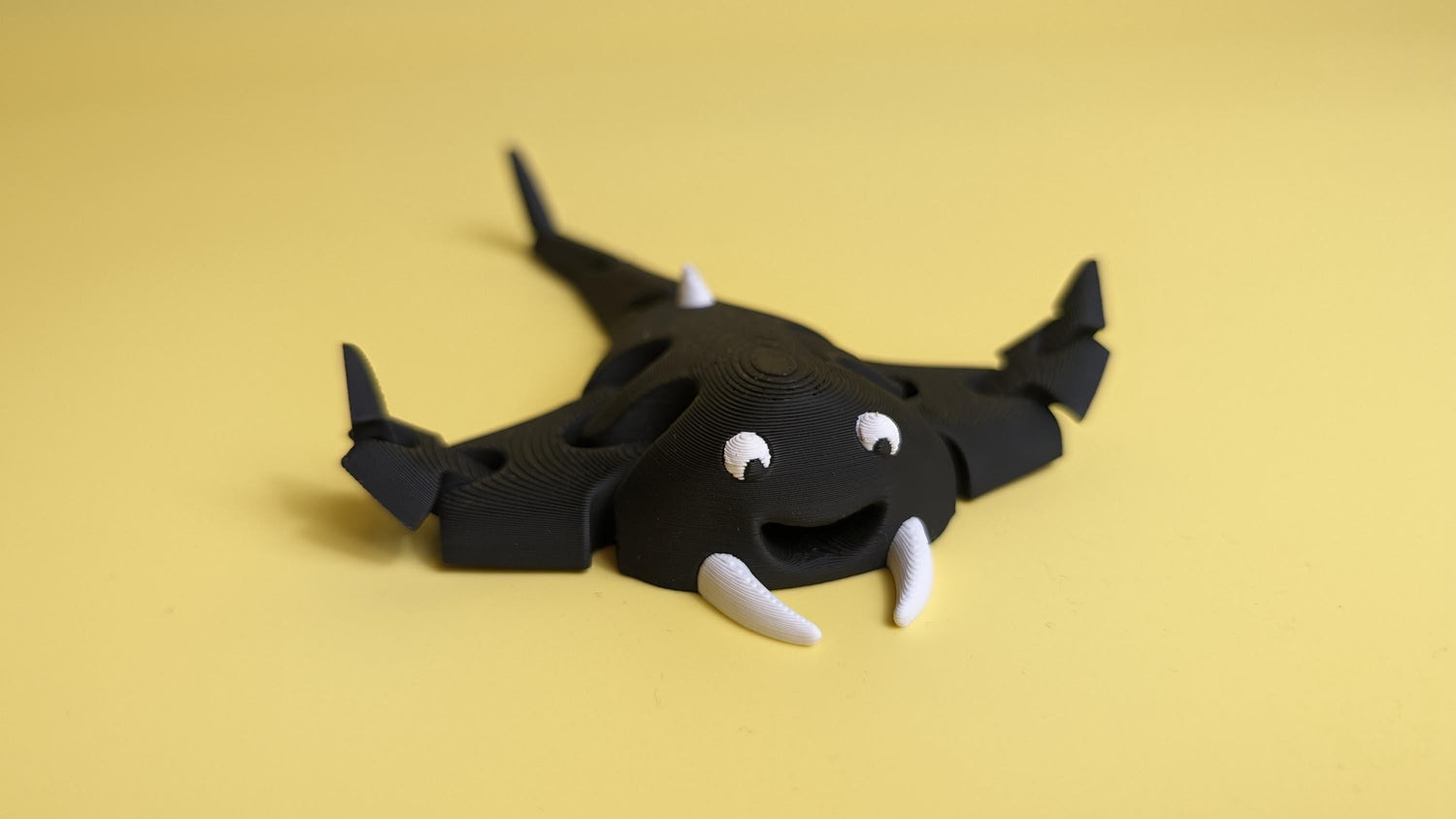 Black toy figurine designed as a friendly sea creature, part of the Toys & Figurines collection.