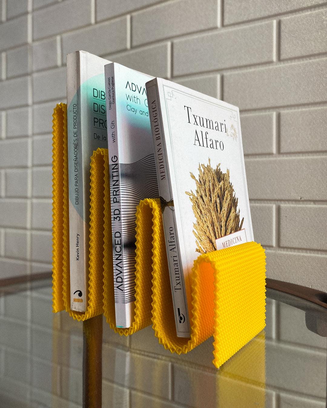 Colorful stationery books organized in a stylish yellow book holder, showcasing modern designs for stationery lovers.