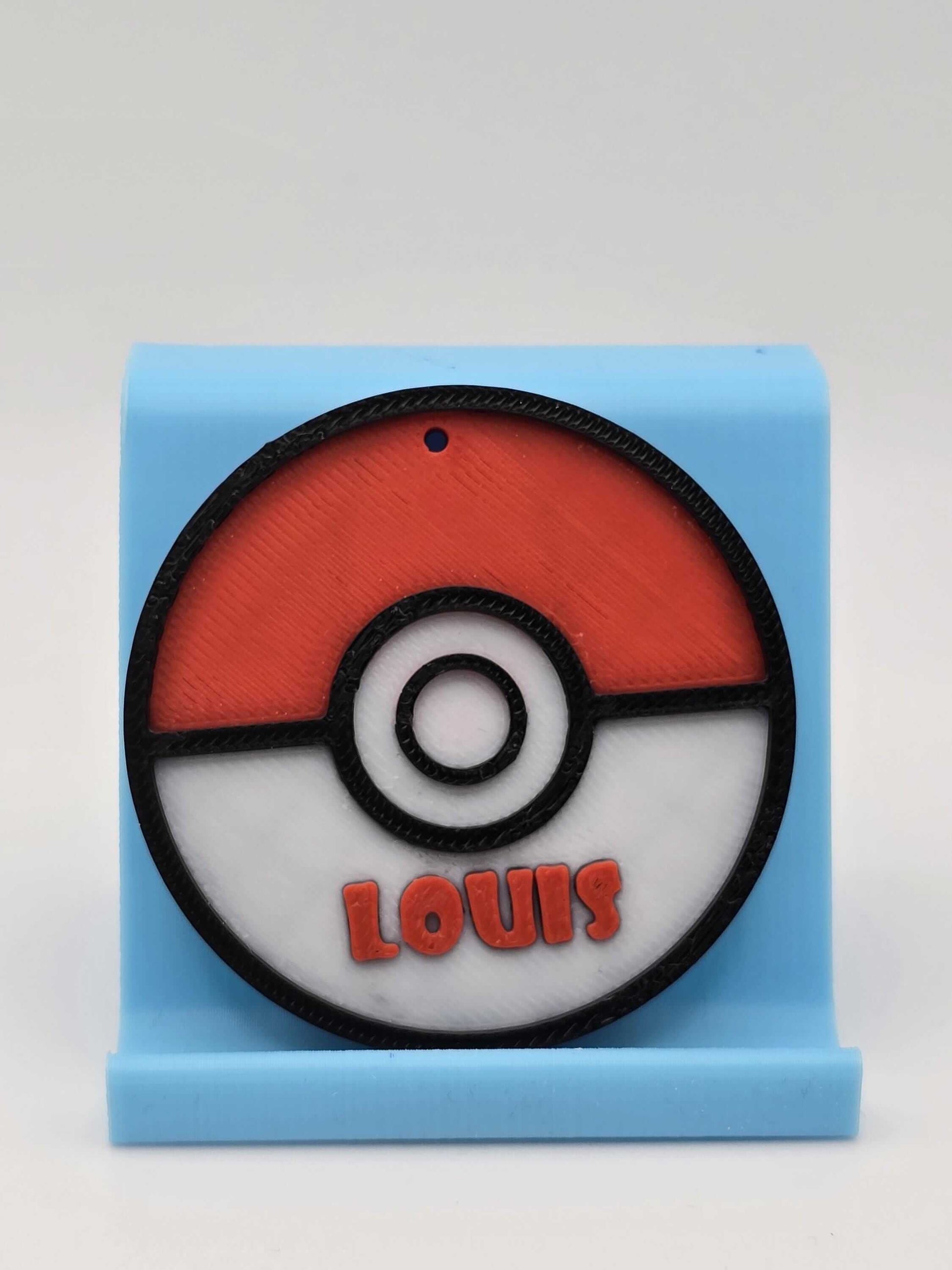 Personalized Pokemon keychain featuring a Pokeball design with the name Louis, perfect for Pokemon fans.