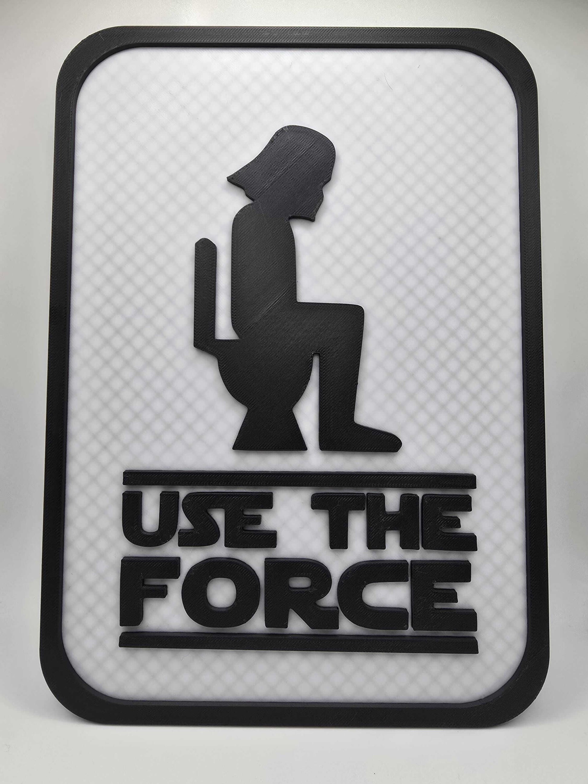 Funny bathroom decor sign featuring a silhouette and the phrase "Use The Force" for humorous bathroom wall decoration.