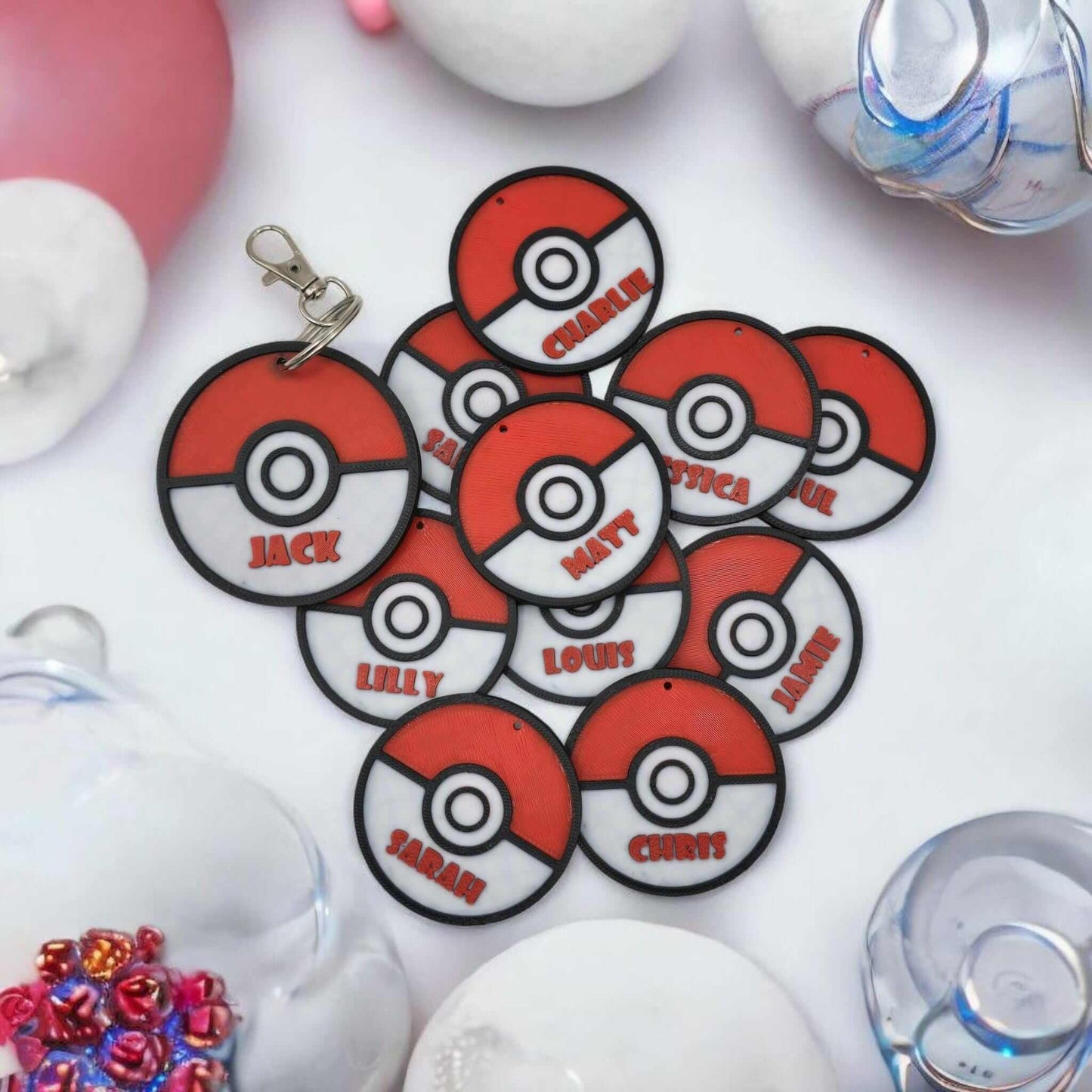 Personalized Pokemon keychain with multiple Pokeballs featuring names like Jack, Charlie, and Lily.