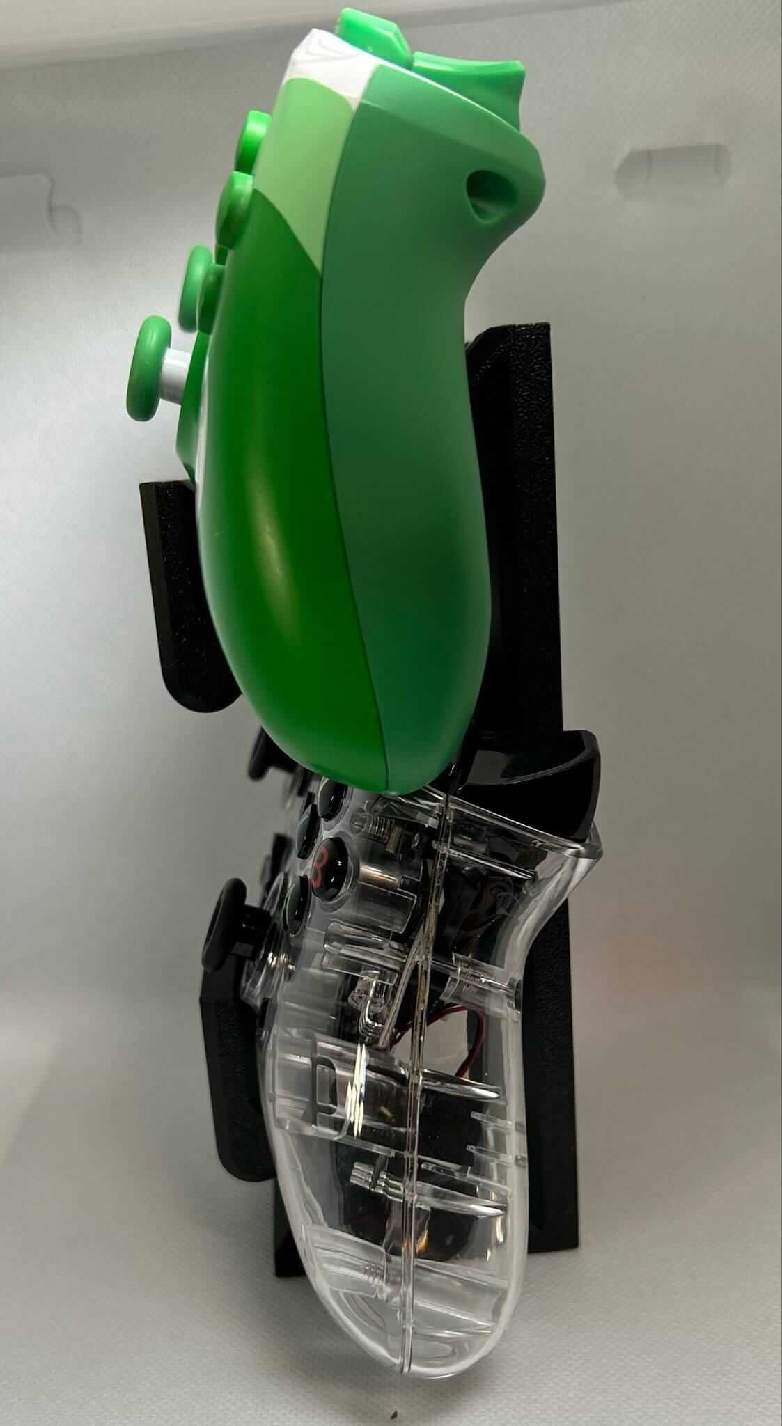 Close-up of Xbox Switch controller stand holding a green controller, showcasing its stylish design and organization.