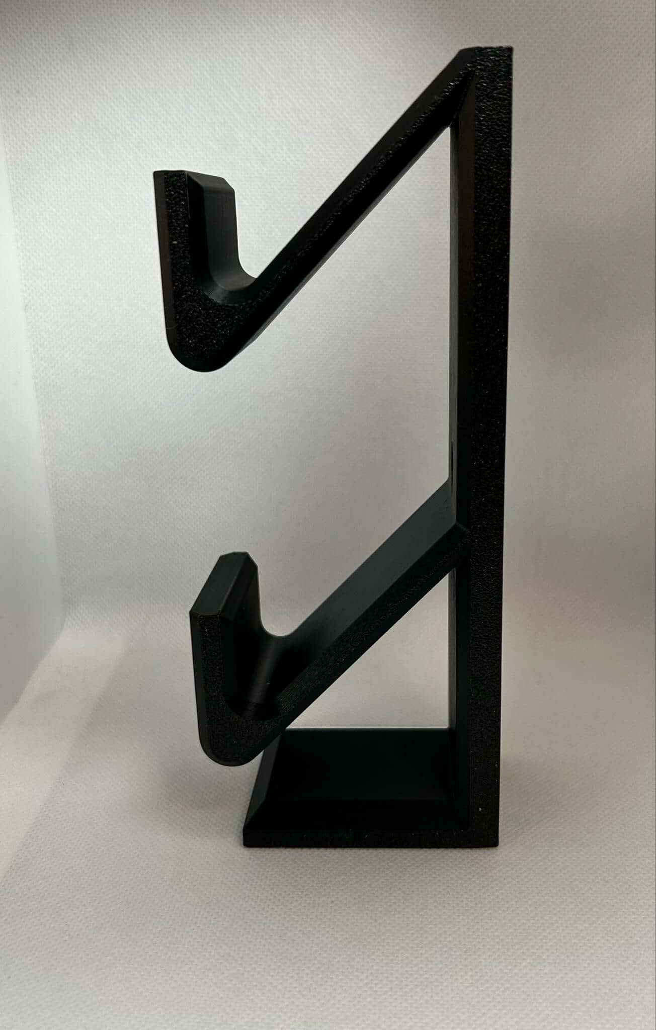 Stylish Xbox Switch controller stand in black, designed for organized gaming setup and easy access.