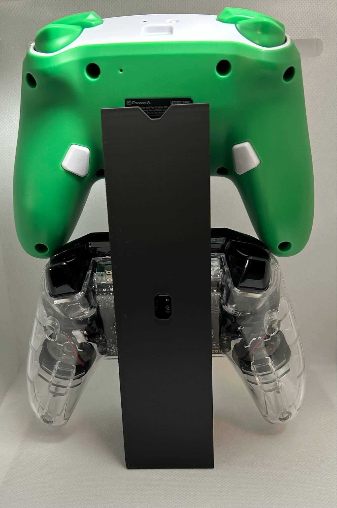 Xbox Switch controller stand displaying a green and clear controller for organized gaming setup.