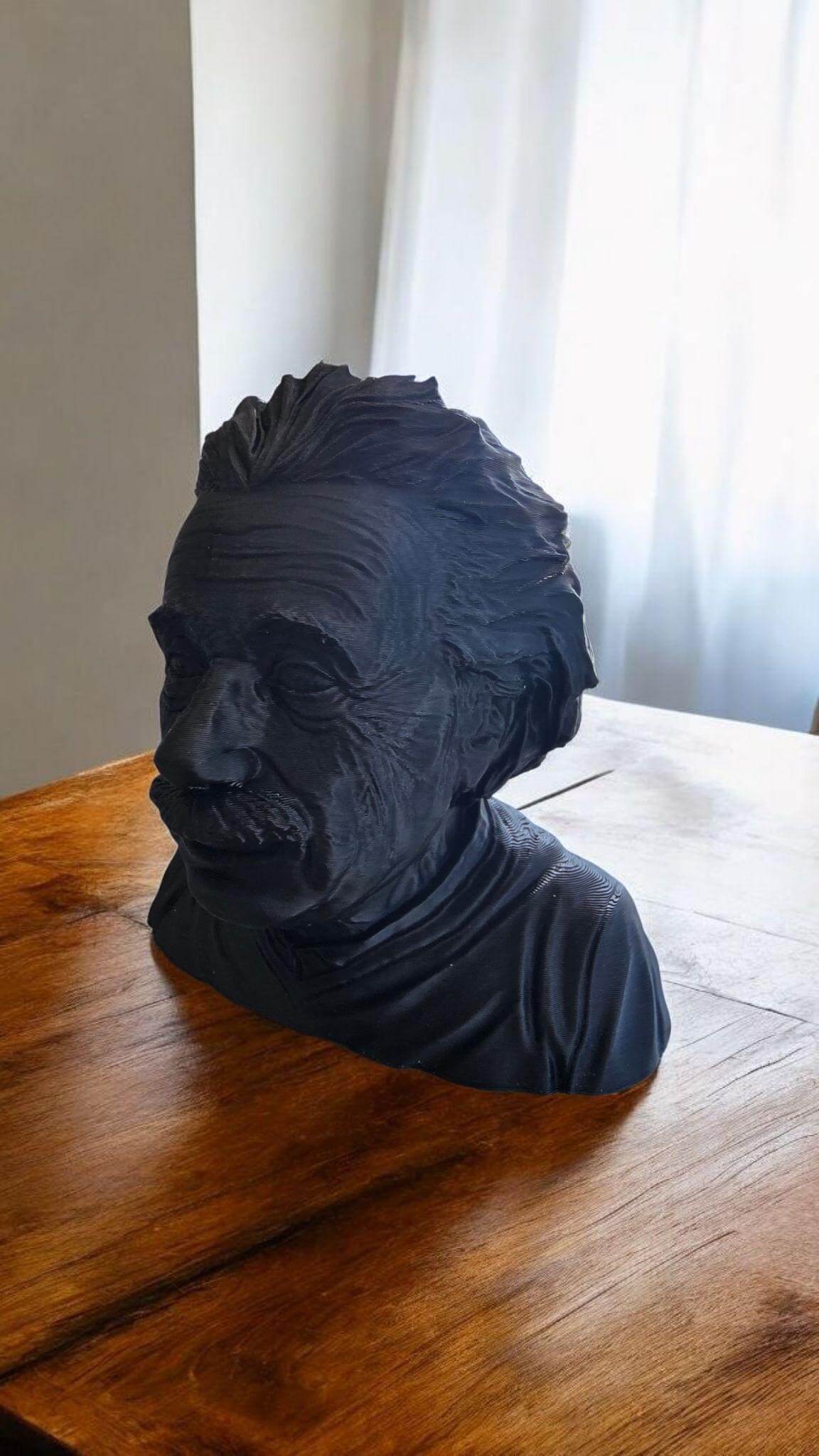 3D printed Einstein sculpture on a wooden table, showcasing intricate details of Einstein's iconic features.