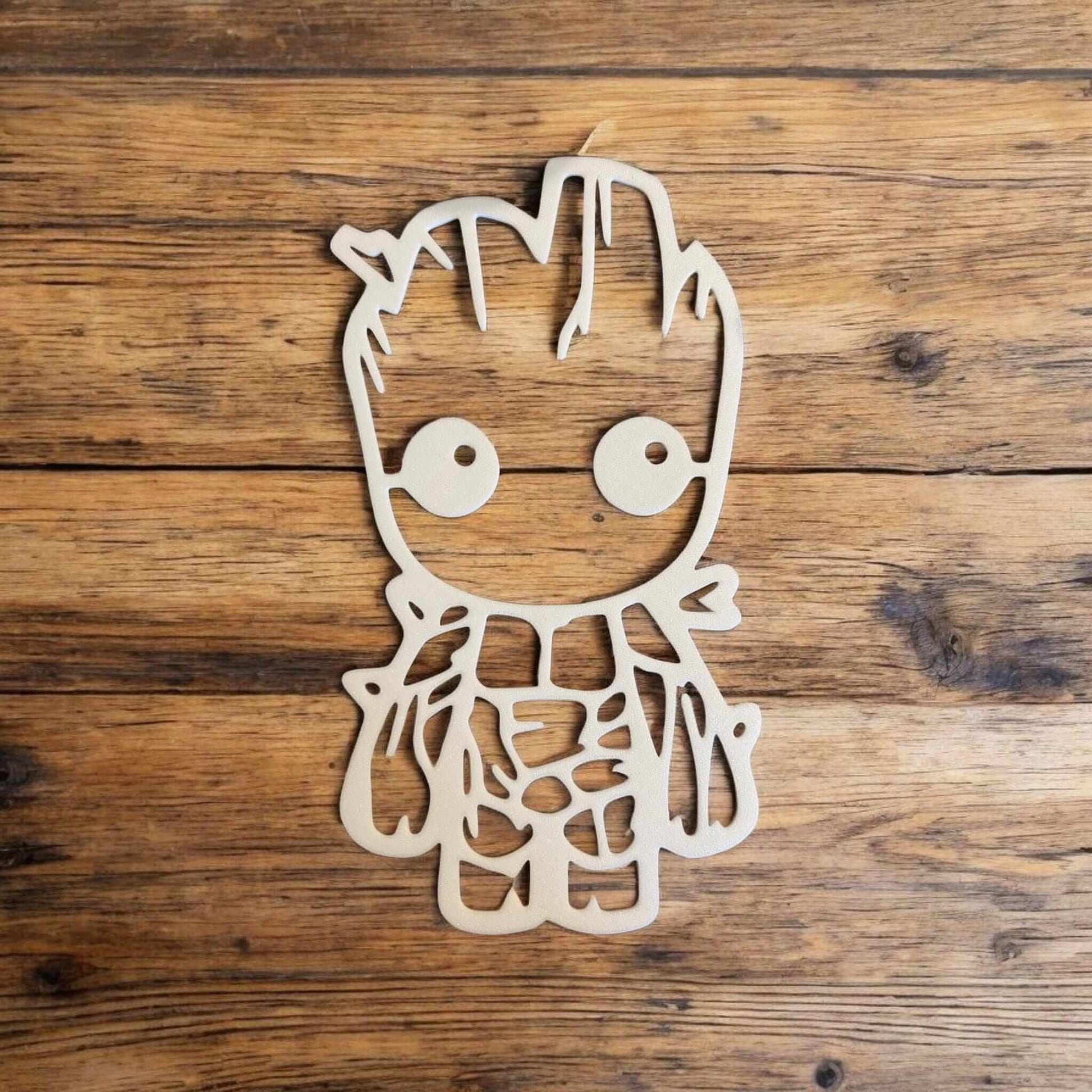 Baby Groot nursery decor displayed on wooden background, perfect for adding charm to a child's room.