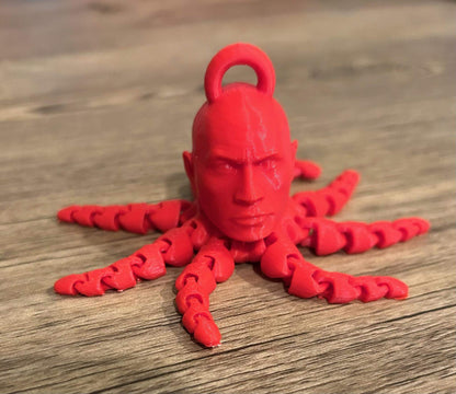 Dwayne The Rocktopus keychain fidget in red, featuring a head and eight tentacles, ideal for fidgeting and conversation.