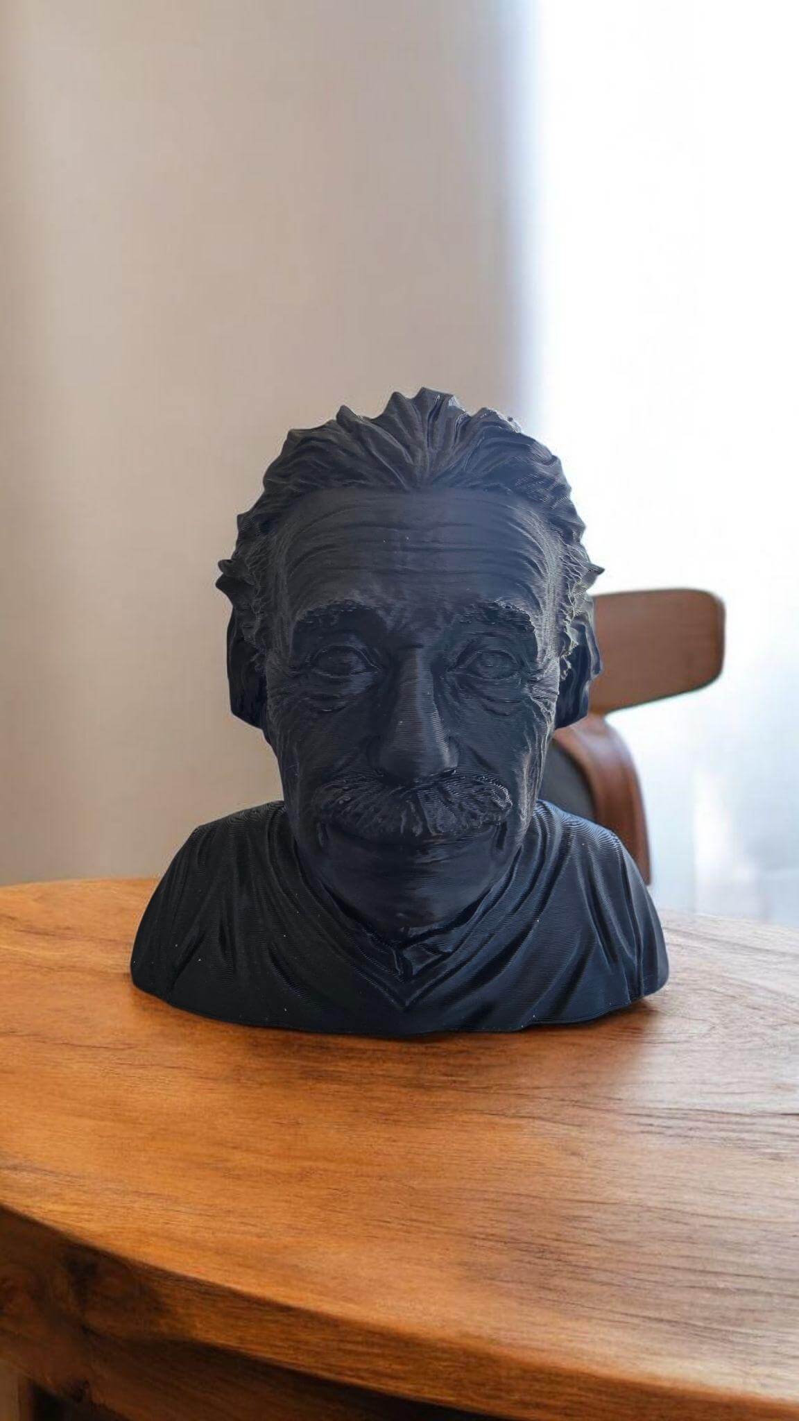 3D printed Einstein sculpture displayed on wooden table, showcasing intricate details of Einstein's features.