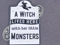 Halloween porch decor sign featuring a witch silhouette with the text 'A Witch Lives Here with Her Little Monsters'