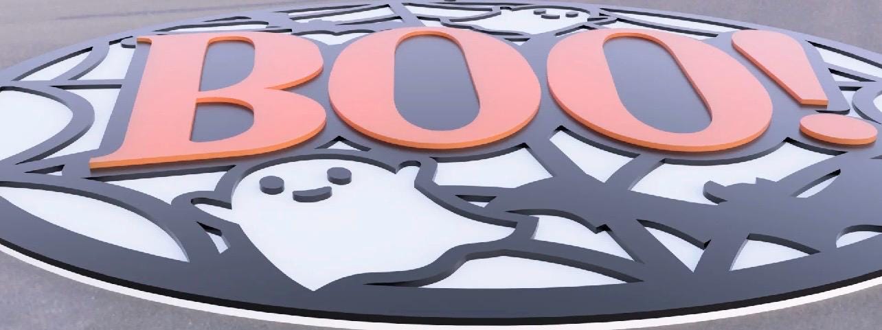 Halloween wall decor sign featuring a bold orange 'BOO!' with playful ghosts and a web design.