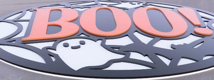 Halloween wall decor sign featuring a bold orange 'BOO!' with playful ghosts and a web design.