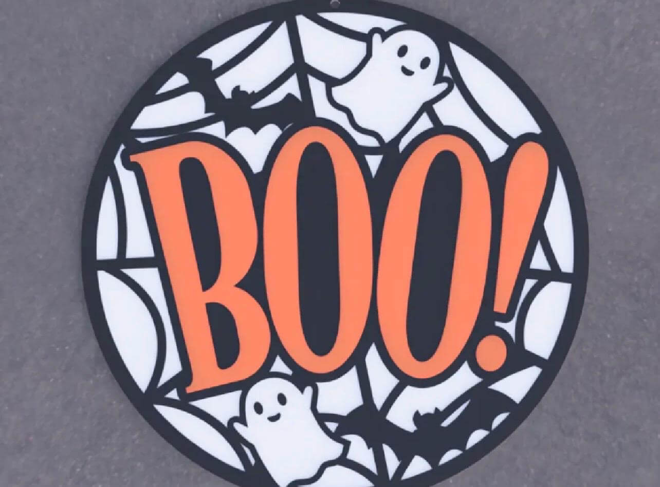 Halloween wall decor sign featuring a bold orange 'BOO!' with playful ghosts and bats in a web design.