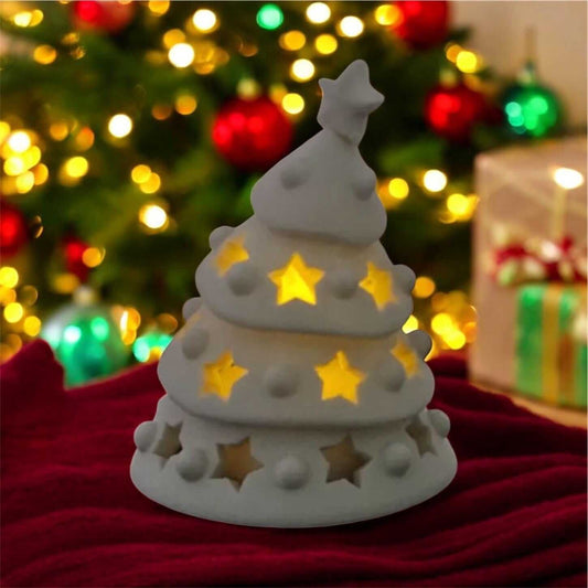 lighted 3D printed Christmas tree glowing softly with warm LED lights and star cutouts, festive holiday decor.